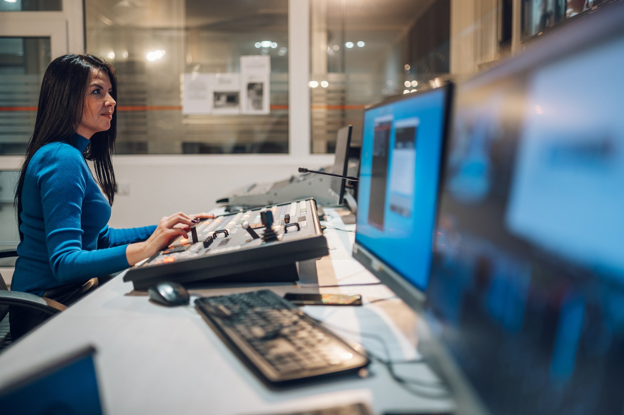 middle-aged-woman-using-equipment-in-control-room-1
